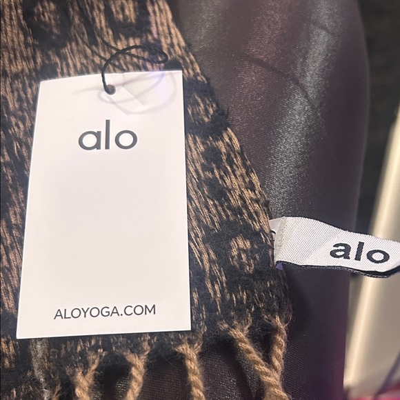 Alo cashmere silk scarf one side is tan and black.